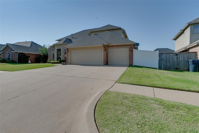 view of front of house featuring a front yard and a garage