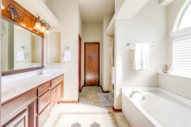 bathroom featuring tile patterned flooring, a bath, a healthy amount of sunlight, and vanity