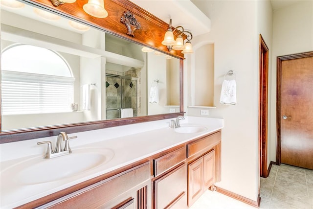 bathroom featuring tile patterned flooring, a shower with door, and vanity