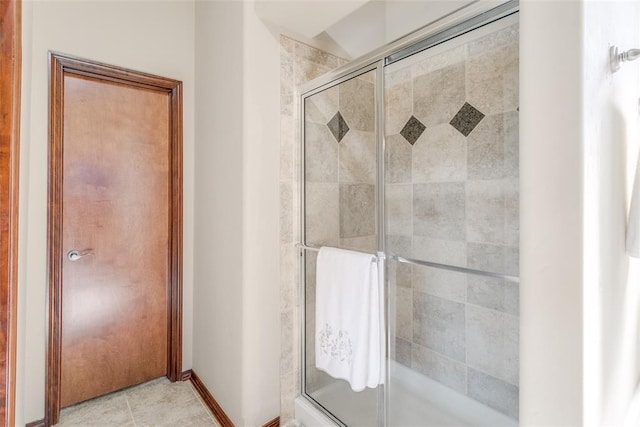 bathroom featuring a shower with door