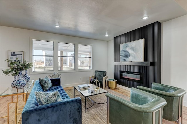 living room with a fireplace and light hardwood / wood-style flooring