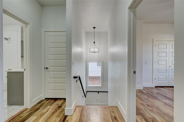 entrance foyer featuring light wood-type flooring and a chandelier