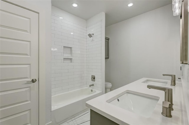 full bathroom with toilet, tiled shower / bath, and vanity