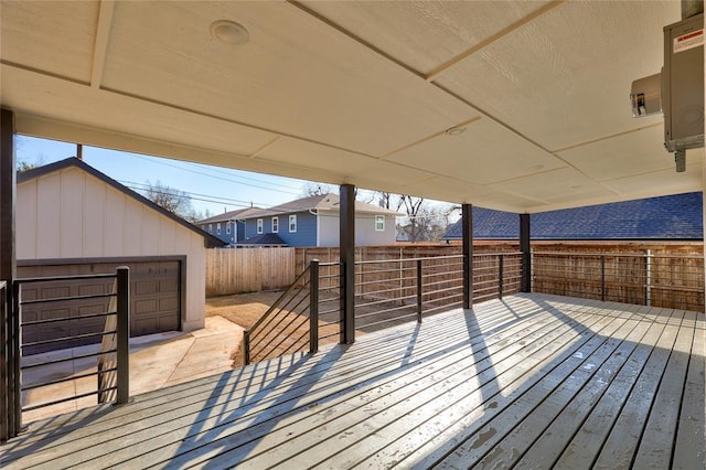 deck with a garage and an outbuilding