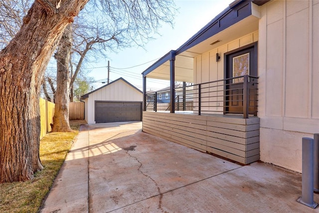 view of side of property with a garage and an outbuilding