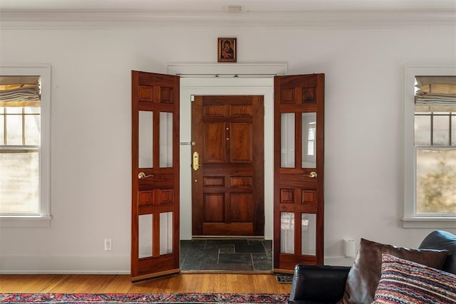 foyer featuring crown molding