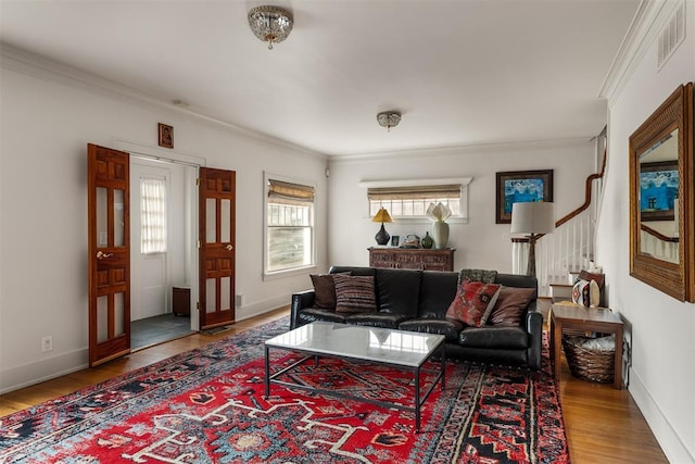 sitting room featuring crown molding, plenty of natural light, and hardwood / wood-style floors