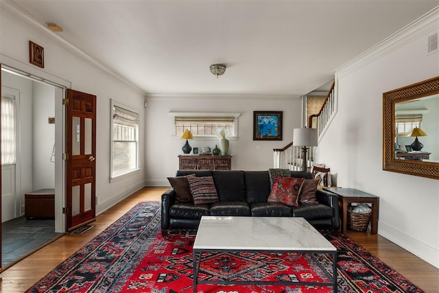 living room featuring ornamental molding and wood-type flooring