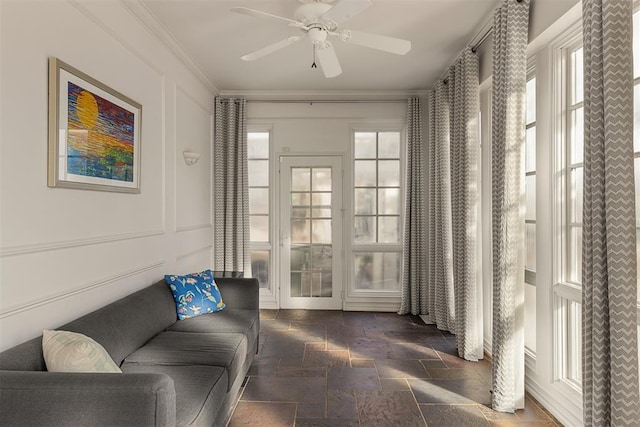 living room with crown molding and ceiling fan