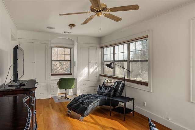 sitting room with ceiling fan and light wood-type flooring