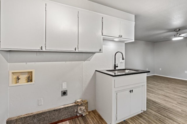 clothes washing area featuring hookup for an electric dryer, ceiling fan, wood-type flooring, washer hookup, and sink