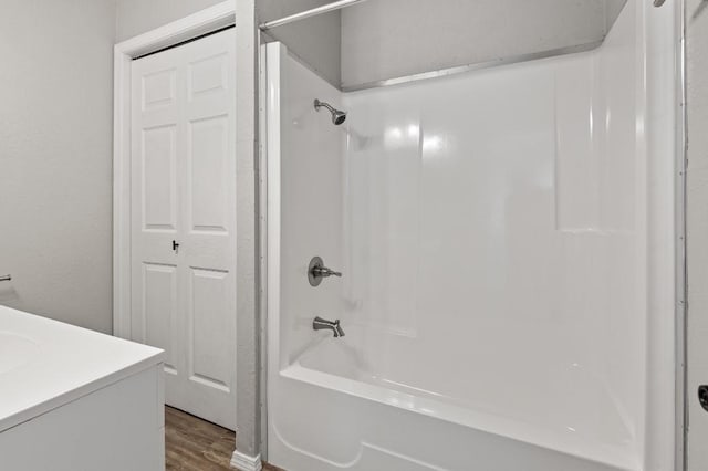 bathroom featuring vanity, shower / bathtub combination, and hardwood / wood-style flooring