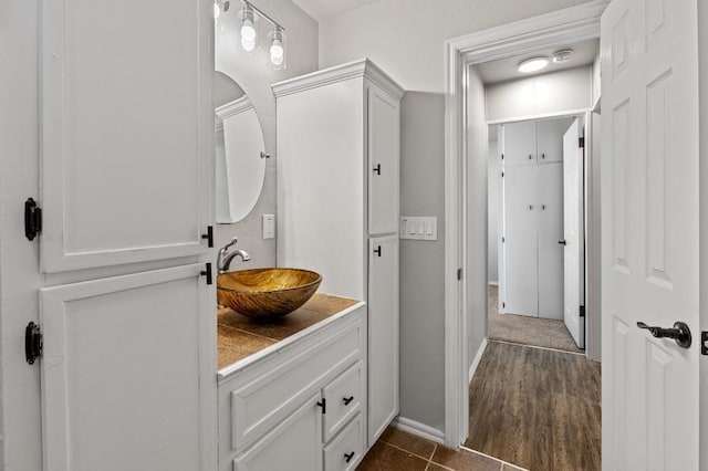 bathroom with hardwood / wood-style flooring and vanity