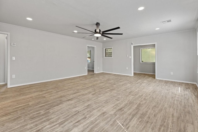 spare room featuring ceiling fan, a healthy amount of sunlight, and light wood-type flooring