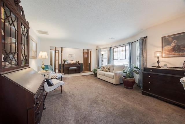 carpeted living room featuring a textured ceiling