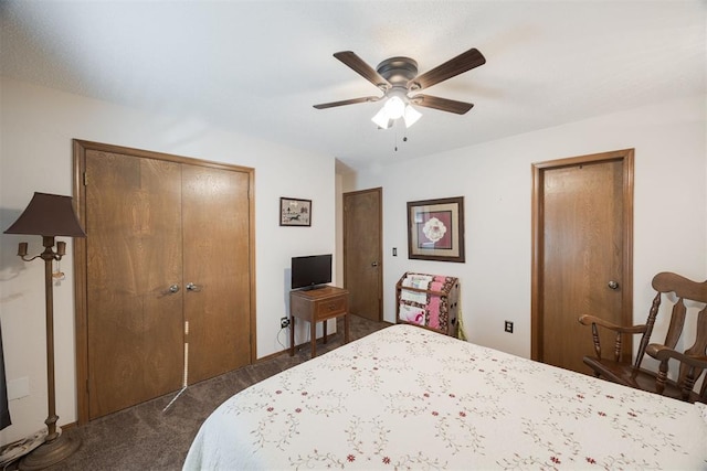 bedroom featuring ceiling fan, dark carpet, and a closet