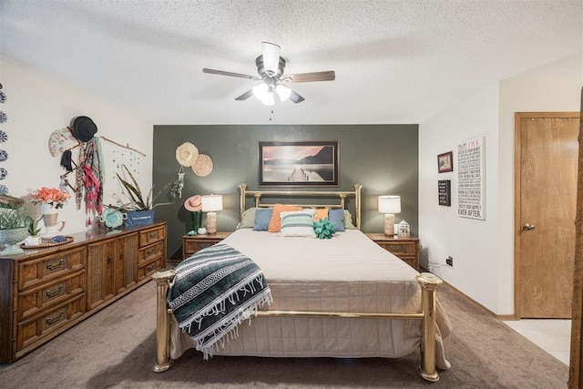 carpeted bedroom with ceiling fan and a textured ceiling