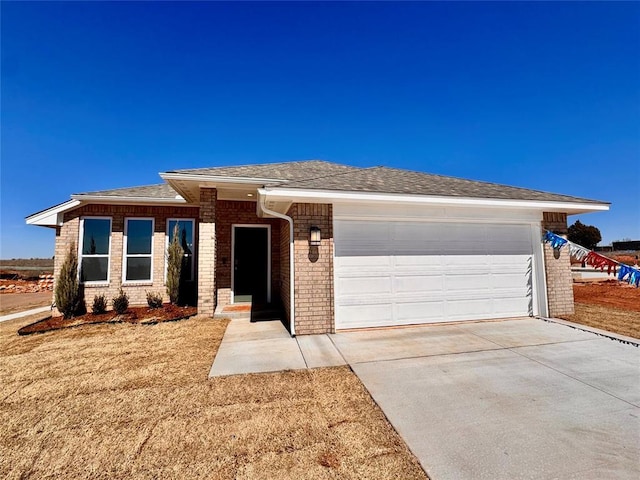 view of front facade with brick siding, driveway, an attached garage, and a shingled roof