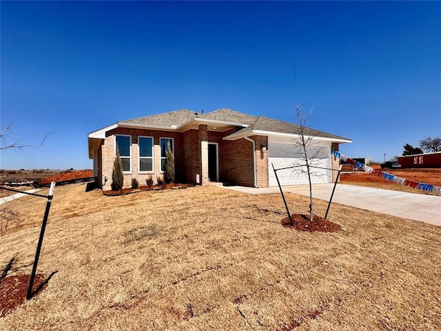 view of front facade featuring brick siding, concrete driveway, and an attached garage