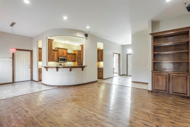 unfurnished living room featuring light wood-type flooring