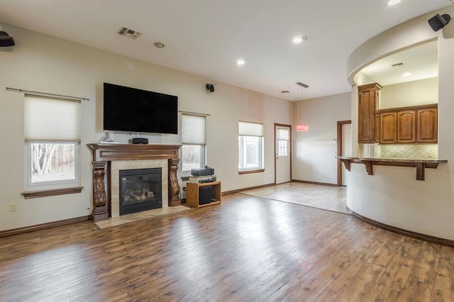 unfurnished living room with a healthy amount of sunlight and light wood-type flooring