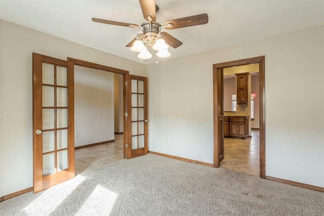 unfurnished room with french doors, ceiling fan, and light carpet