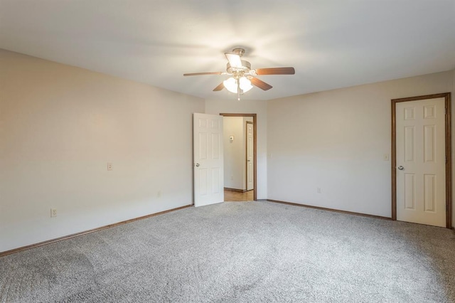 carpeted spare room with ceiling fan