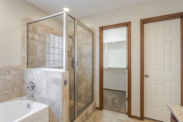 bathroom featuring plus walk in shower, tile patterned floors, and vanity