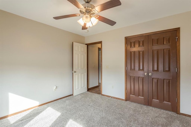 unfurnished bedroom featuring light carpet, ceiling fan, and a closet