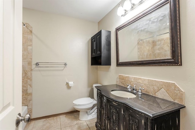 bathroom with tile patterned flooring, vanity, and toilet