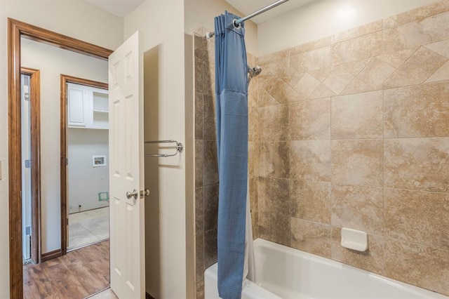 bathroom featuring shower / bathtub combination with curtain and hardwood / wood-style floors