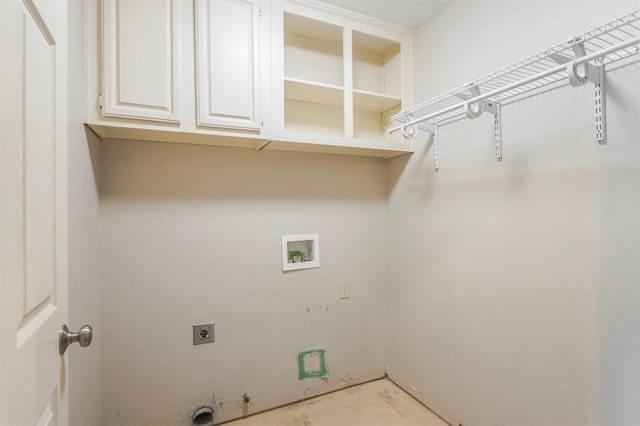 clothes washing area featuring cabinets, hookup for an electric dryer, and hookup for a washing machine