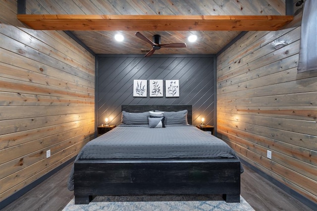 unfurnished bedroom featuring ceiling fan, dark hardwood / wood-style floors, and wooden walls