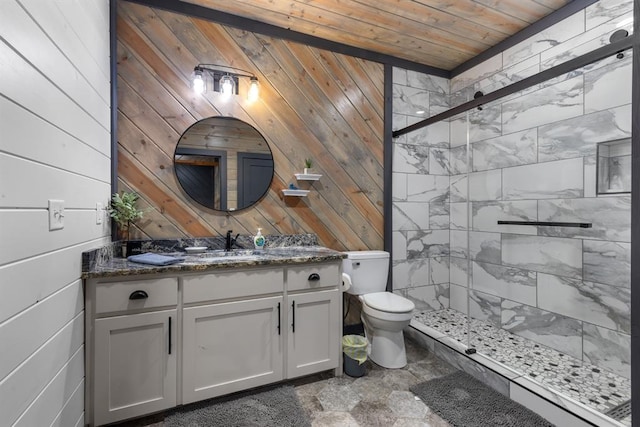 bathroom with a shower with door, vanity, toilet, wood walls, and wooden ceiling