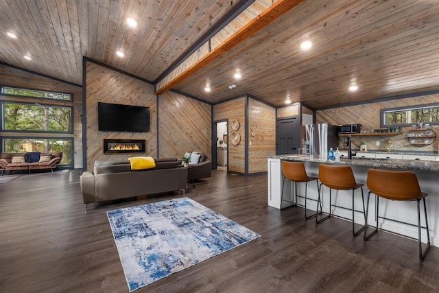 living room featuring vaulted ceiling, dark hardwood / wood-style floors, a fireplace, wooden walls, and wooden ceiling