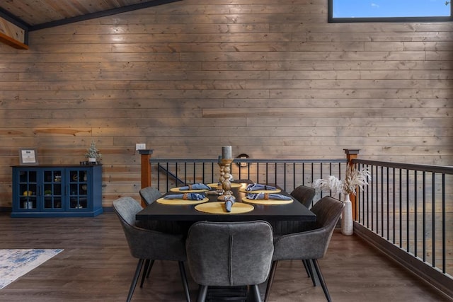 dining space with dark wood-type flooring, wood walls, wood ceiling, and vaulted ceiling