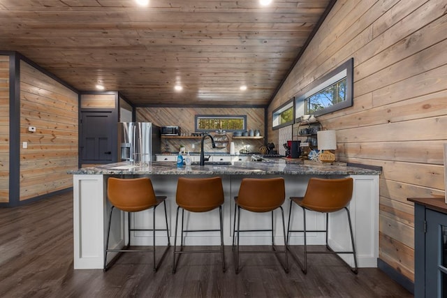 kitchen with lofted ceiling, wood ceiling, stainless steel fridge with ice dispenser, and dark wood-type flooring