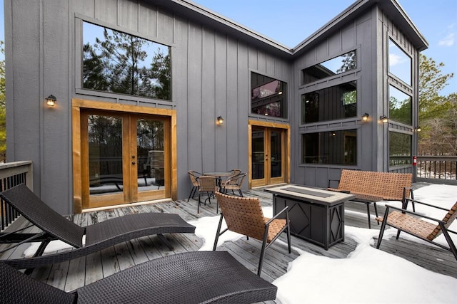 rear view of property with an outdoor fire pit and french doors