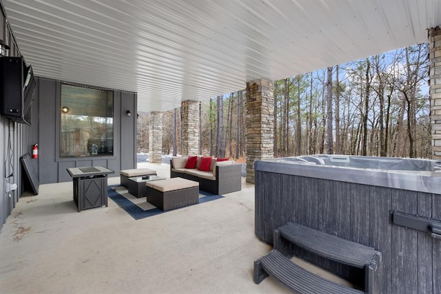 view of patio / terrace featuring a hot tub and an outdoor living space