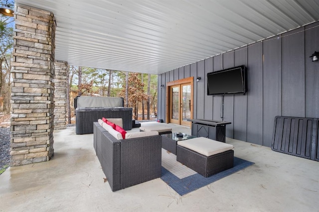 view of patio with a hot tub, an outdoor hangout area, and french doors