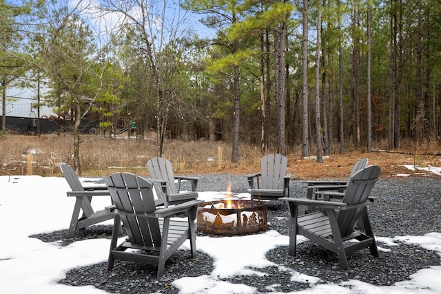 snow covered patio with a fire pit