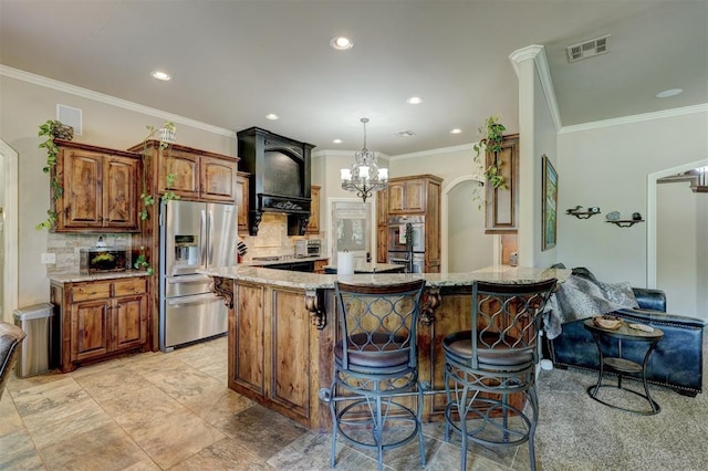 kitchen featuring light stone counters, stainless steel appliances, a kitchen breakfast bar, and visible vents