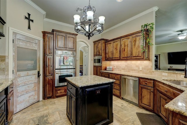 kitchen with tasteful backsplash, light stone countertops, arched walkways, stainless steel appliances, and a sink