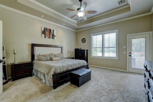 carpeted bedroom with visible vents, crown molding, a tray ceiling, and access to outside