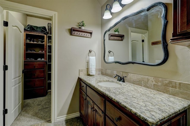 bathroom featuring vanity and baseboards