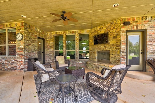 view of patio featuring an outdoor living space with a fireplace and ceiling fan