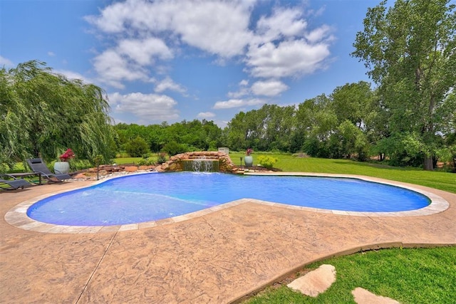 outdoor pool with a yard and a patio