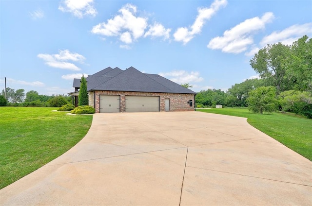 view of front of property with a garage, driveway, brick siding, and a front yard