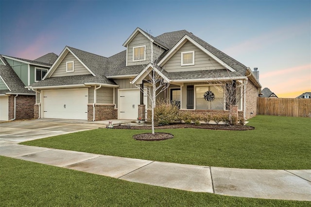 craftsman-style home with a garage and a yard