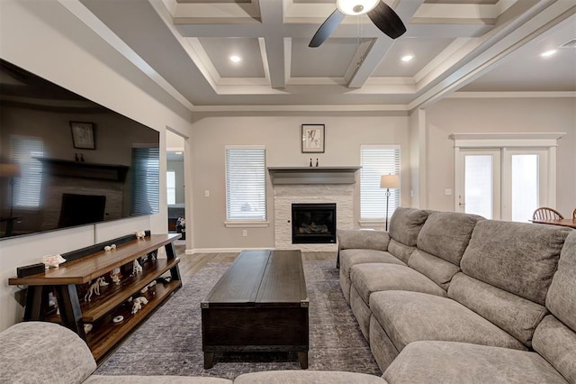 living room featuring coffered ceiling, ceiling fan, crown molding, dark wood-type flooring, and beam ceiling